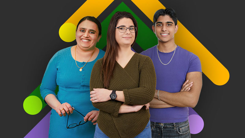 Two women and a man smile at a camera in front of a graphic chevron background