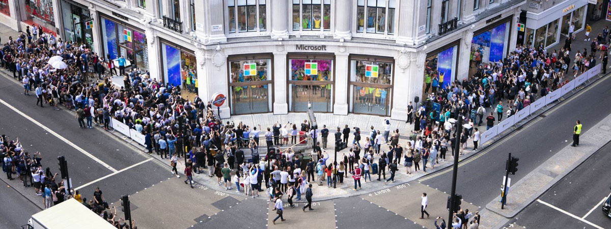 A crowd of people wait outside Microsoft Store at Oxford Circus