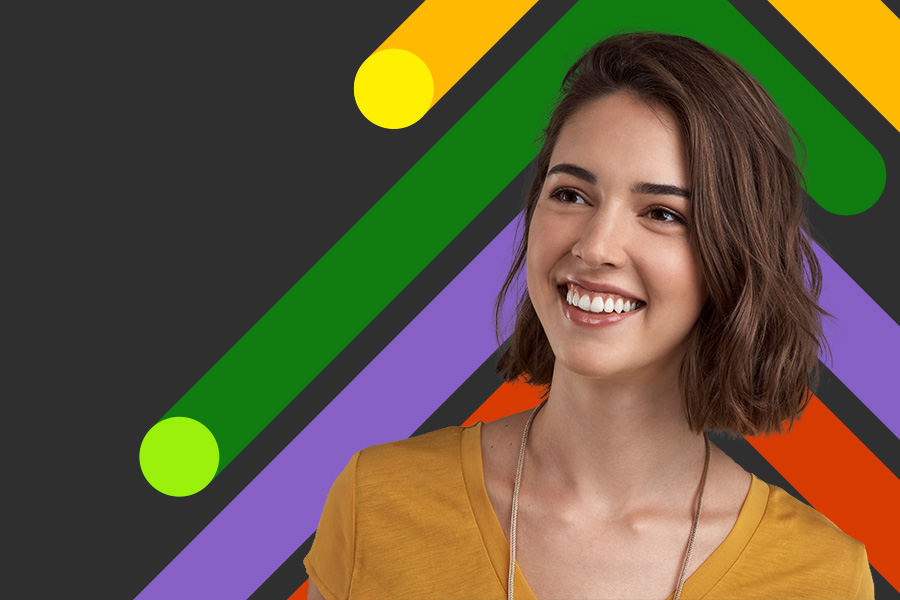 Woman smiling in front of a colourful background
